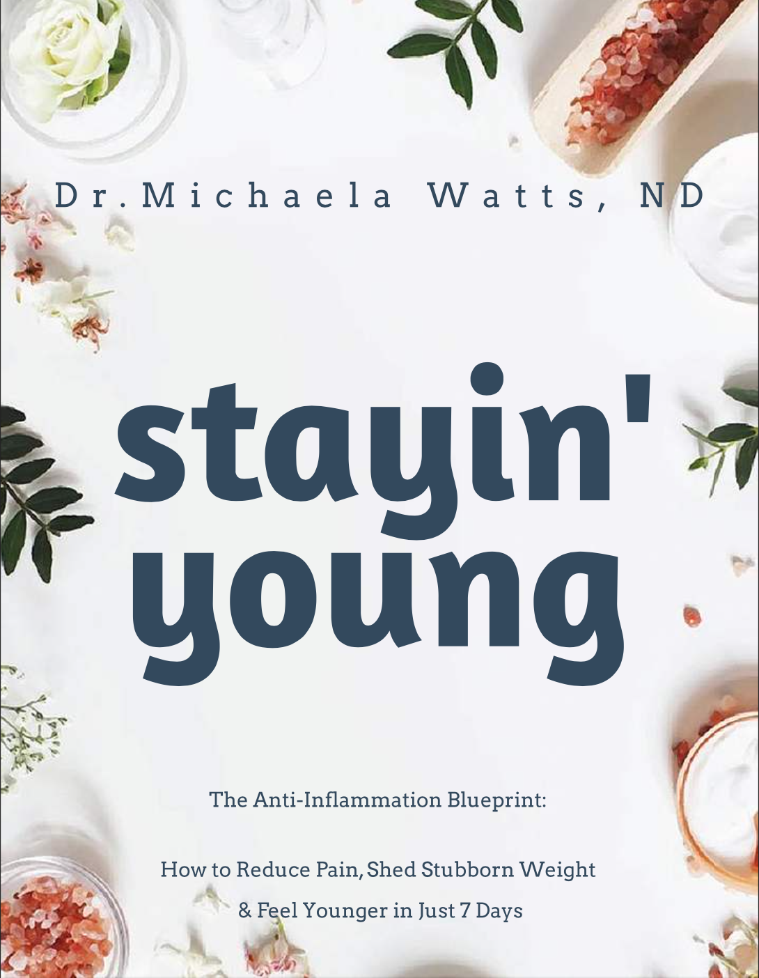Stayin' Young Anti Inflammatory Blue Print Flat lay of the Anti-Inflammation Blueprint book on a table with a glass of lemon water, fresh herbs, and sunlight.